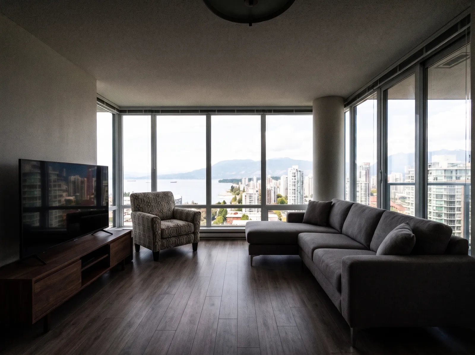 Condo living room, city view straight off the phone: view lost to glare, interior silhouetted