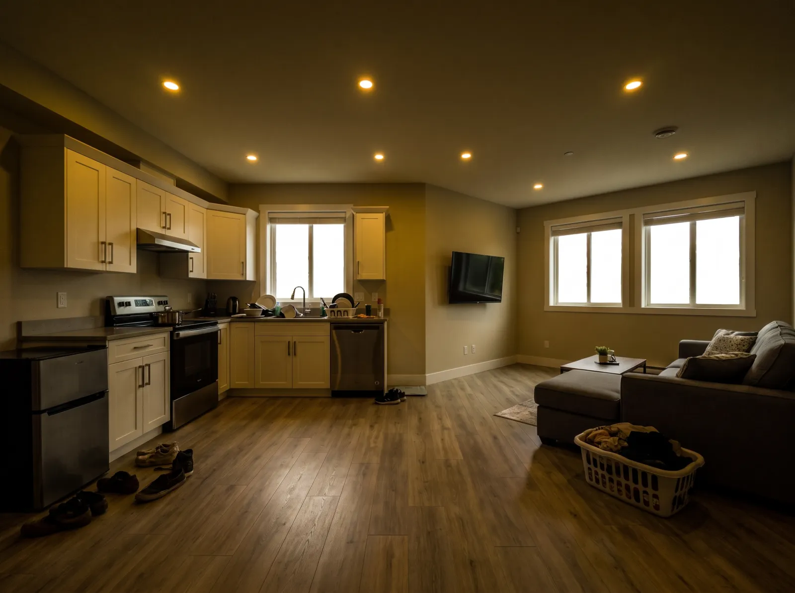 Basement suite straight off the phone: dark, yellow cast, dishes and shoes